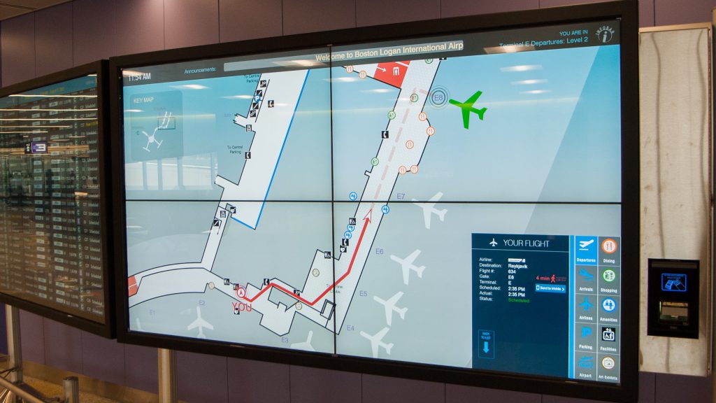 Close up of InfoWall a 2x2 map of Logan Airport featuring Interactive Wayfinding and a boarding pass scanner. 